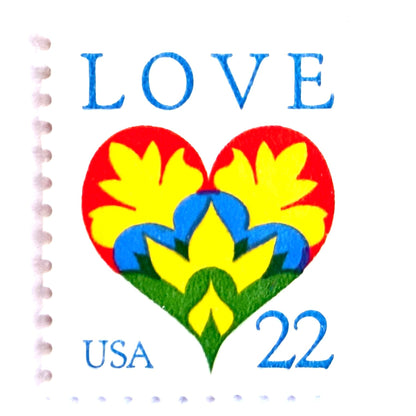 Hearts & Flowers postage stamps from 1987 featuring a colorful folk art heart surrounded by flowers on vintage unused 22-cent USPS postage, Scott 2248.
