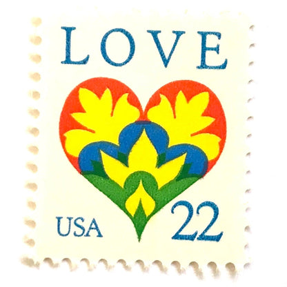 Hearts & Flowers postage stamps from 1987 featuring a colorful folk art heart surrounded by flowers on vintage unused 22-cent USPS postage, Scott 2248.