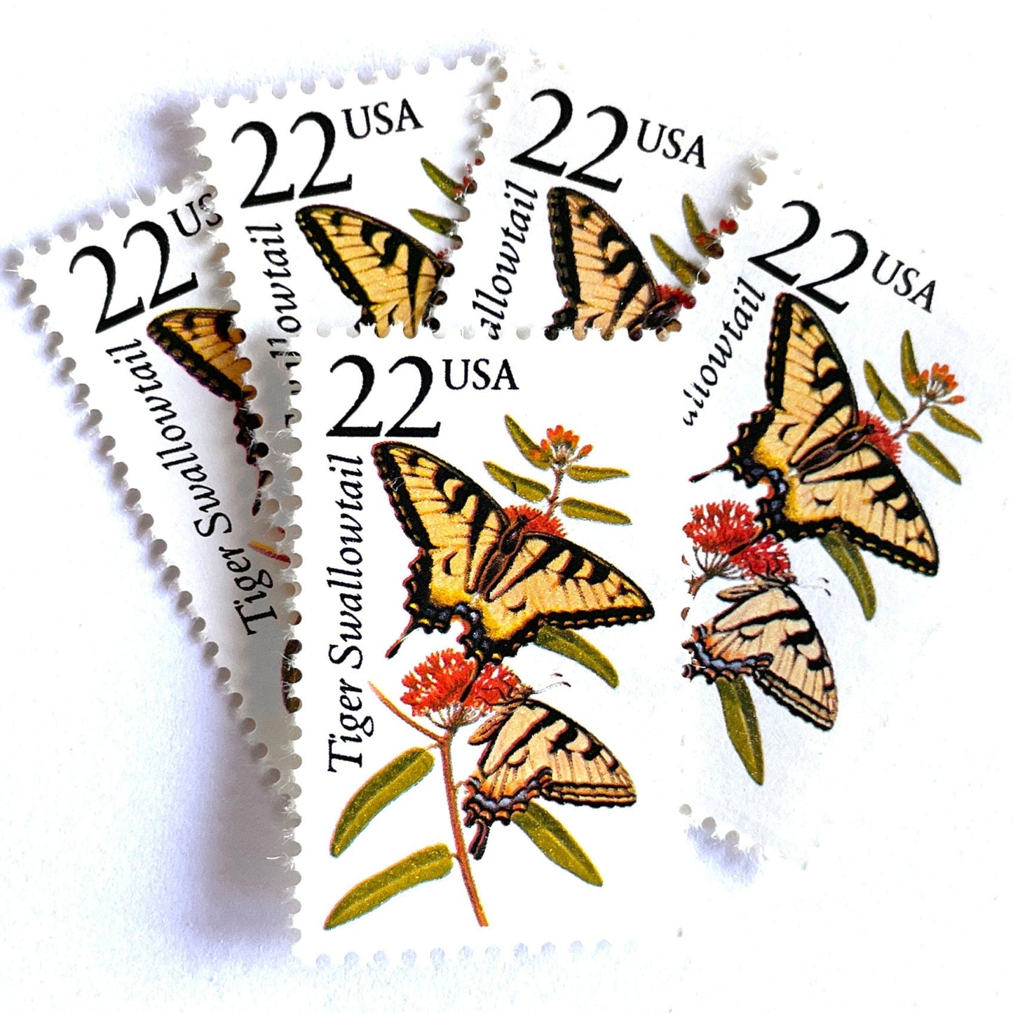 Image of 1987 North American Wildlife Series “Tiger Swallowtail Butterfly” 22-cent unused mail stamps. Scott #2300. Stamp Themes: Wildlife, Nature, Insect, Flying Insect, Butterfly, Pollinator, Flight, Forests, Meadows, Gardens, Wildlife Conservation. Yellow, Black, Red, Multicolored postage stamp.