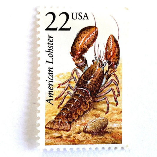 Image of 1987 North American Wildlife Series “Lobster” 22-cent vintage unused USPS mail stamps. Scott #2304. Stamp Themes: Wildlife, Nature, Shellfish, Lobster, Claws, Atlantic Ocean, Coastal, East Coast, New England, Cape Cod, Culinary, Seafood. Gold, Pink, Blue, Black, Multicolored postage stamp. Perfect vintage postage stamp to use for save the date announcements, wedding invitation postage, shower invitations, thank you cards, birthday party invites, and snail mail.