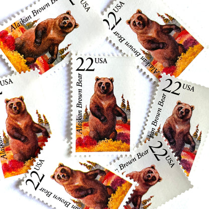 Image of 1987 North American Wildlife Series “Alaskan Brown Bear” 22-cent vintage unused USPS mail stamps. Scott #2310. Stamp Themes: Wildlife, Nature, Bear, Grizzly Bear, Kodiak Bear, Alaska, Autumn, Fall Colors, Memphis Grizzlies, Hunting. Brown, Red, Yellow, Green, Multicolored postage stamp. Perfect vintage postage stamp to use for save the date announcements, wedding invitation postage, shower invitations, thank you cards, birthday party invites, and snail mail.
