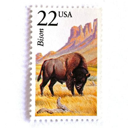 Image of 1987 North American Wildlife Series “Bison” 22-cent vintage unused USPS mail stamps. Scott #2320. Stamp Themes: Wildlife, Nature, Buffalo, Bison, Tatanka, Herd, Grazing, Prairie, Grasslands, University of Colorado Boulder Ralphie, Colorado, Wyoming, Yellowstone, Grand Tetons, Conservation. Brown, Yellow/Gold, Pink, Multicolored postage stamp. Perfect vintage postage stamp to use for save the date announcements, wedding invitation postage, shower invitations, thank you cards, and snail mail.