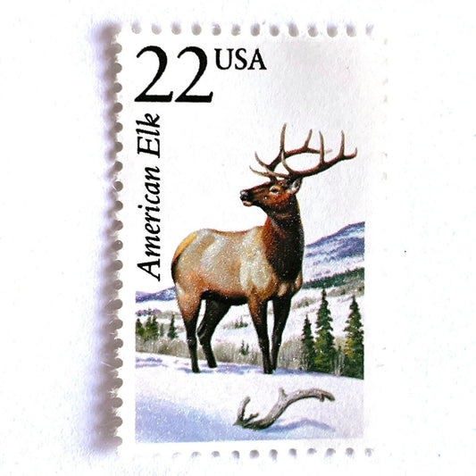 Image of 1987 North American Wildlife Series “American Elk” 22-cent vintage unused USPS mail stamps. Scott #2328. Stamp Themes: Wildlife, Nature, Elk, Deer, Antlers, Buck, Stud, Hunting, Winter, Snow, Mountains, Colorado Rockies, Wyoming Grand Tetons, Idaho, Jackson Hole, Yellowstone. Beige/Brown, Green, White, Multicolored postage stamp. Perfect vintage postage stamp to use for save the date announcements, wedding invitation postage, shower invitations, thank you cards, and snail mail.