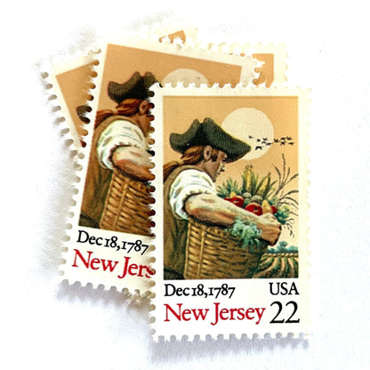 Image of New Jersey Statehood postage stamps from the 1987 Bicentenary Statehood series, featuring a farmer carrying a basket of produce on vintage unused 22-cent USPS postage, Scott 2338.