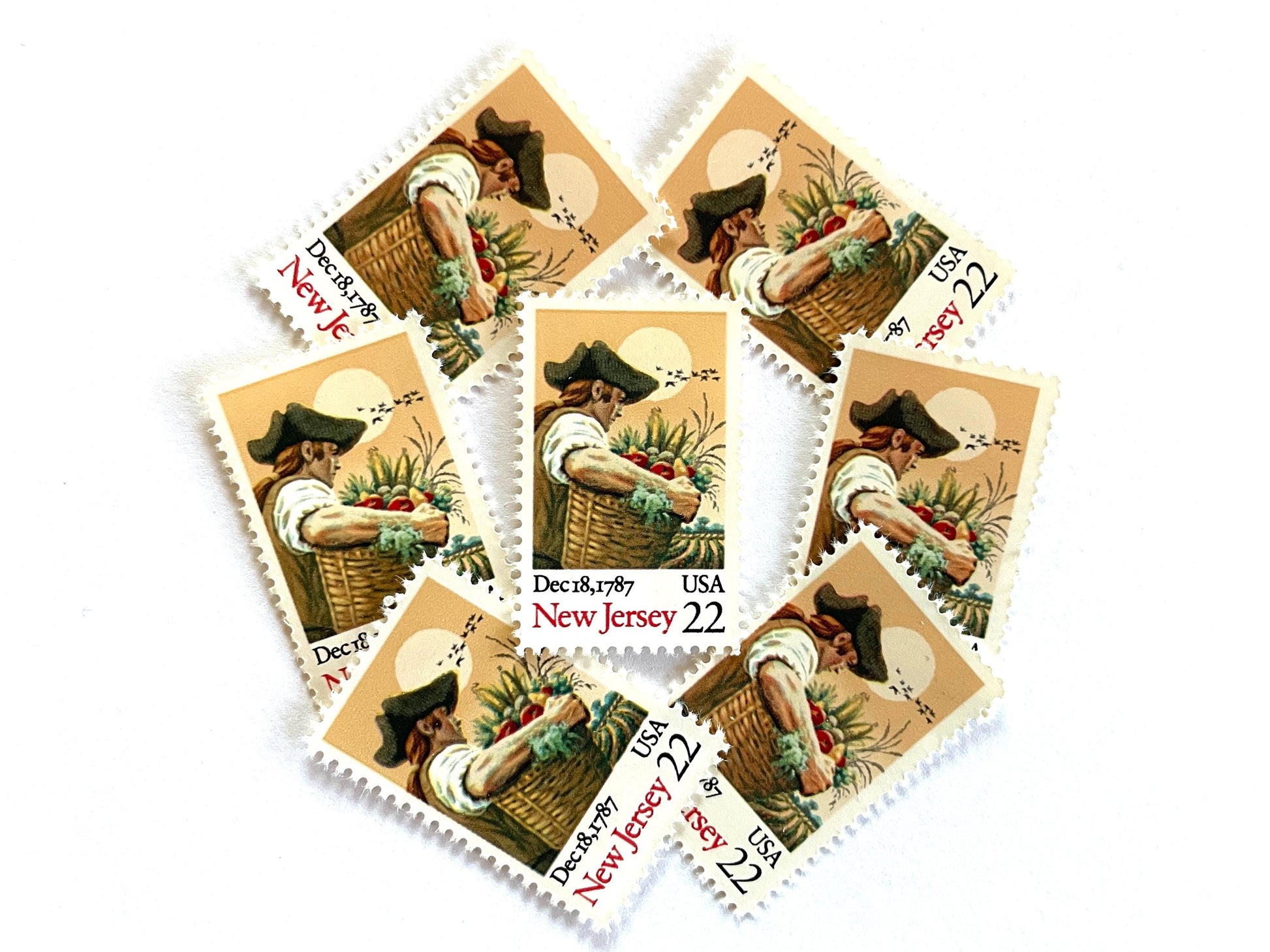Image of New Jersey Statehood postage stamps from the 1987 Bicentenary Statehood series, featuring a farmer carrying a basket of produce on vintage unused 22-cent USPS postage, Scott 2338.