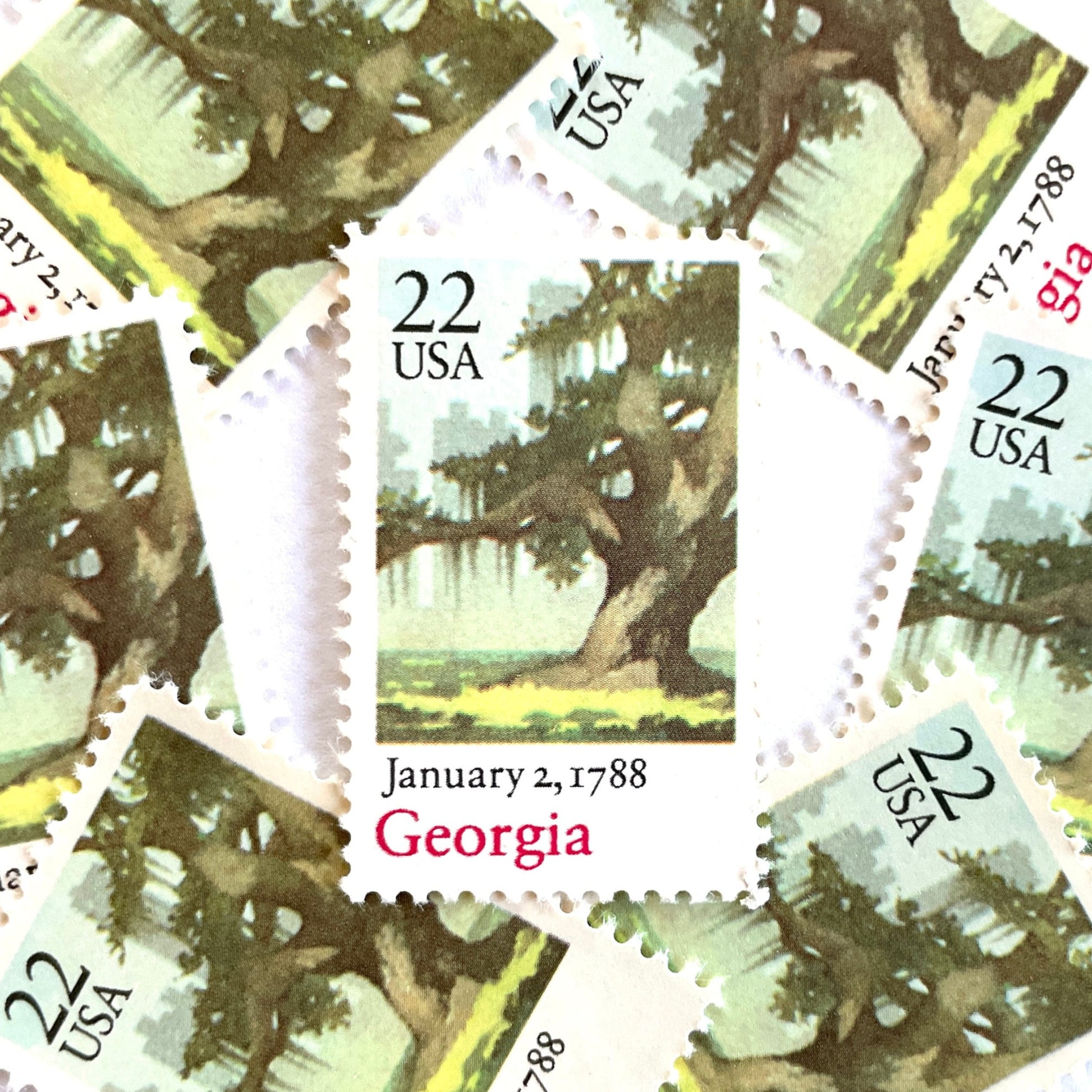 Image of Georgia Statehood postage stamps from the 1988 Bicentenary Statehood series, featuring a green live oak tree with Spanish moss and Atlanta skyline on vintage unused 22-cent USPS postage, Scott 2339.