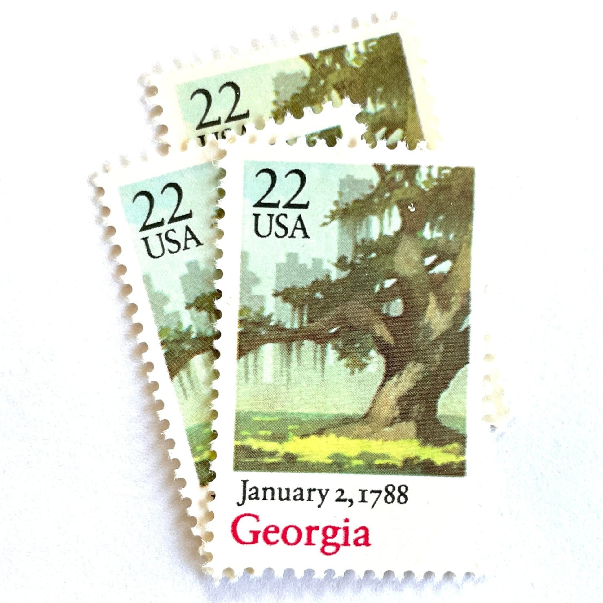 Image of Georgia Statehood postage stamps from the 1988 Bicentenary Statehood series, featuring a green live oak tree with Spanish moss and Atlanta skyline on vintage unused 22-cent USPS postage, Scott 2339.
