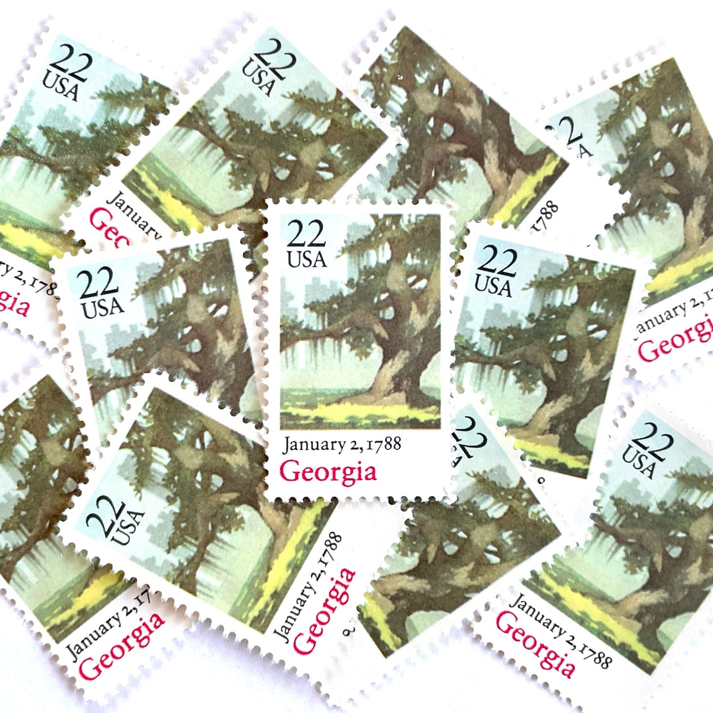 Image of Georgia Statehood postage stamps from the 1988 Bicentenary Statehood series, featuring a green live oak tree with Spanish moss and Atlanta skyline on vintage unused 22-cent USPS postage, Scott 2339.