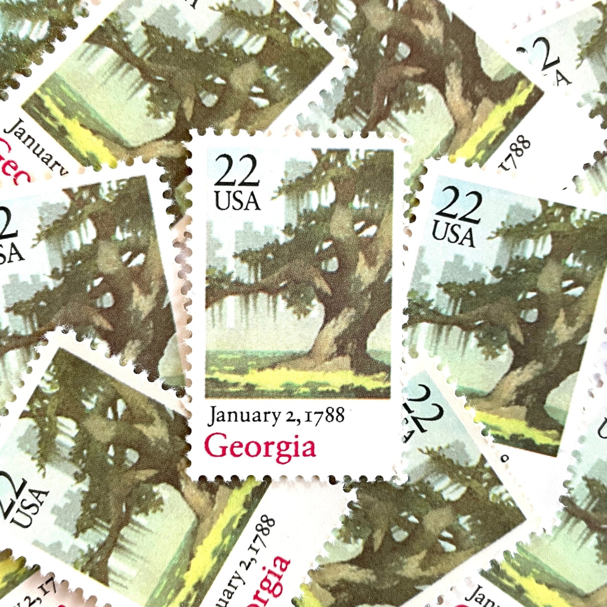 Image of Georgia Statehood postage stamps from the 1988 Bicentenary Statehood series, featuring a green live oak tree with Spanish moss and Atlanta skyline on vintage unused 22-cent USPS postage, Scott 2339.