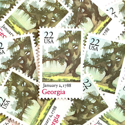 Image of Georgia Statehood postage stamps from the 1988 Bicentenary Statehood series, featuring a green live oak tree with Spanish moss and Atlanta skyline on vintage unused 22-cent USPS postage, Scott 2339.