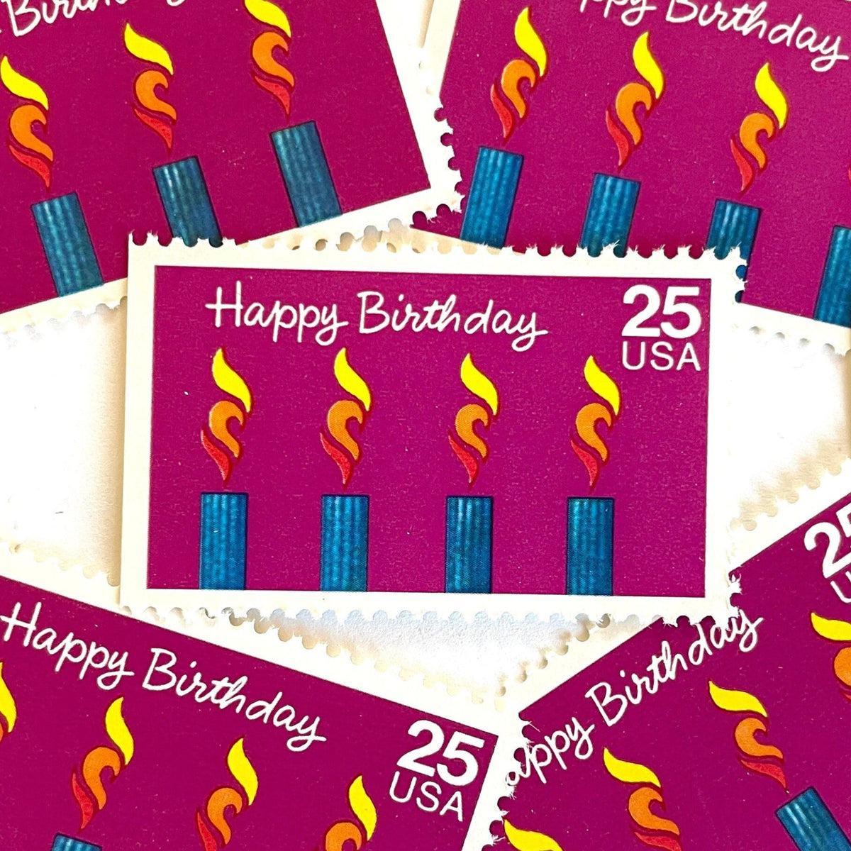 Happy Birthday postage stamps from 1988 featuring four colorful burning candles against a purple background on vintage unused 25-cent USPS postage, Scott 2395.