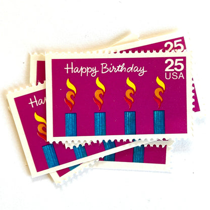 Happy Birthday postage stamps from 1988 featuring four colorful burning candles against a purple background on vintage unused 25-cent USPS postage, Scott 2395.