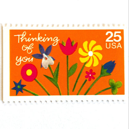 Thinking of You postage stamps from 1988 featuring colorful folk art flowers against a sunny orange background on vintage unused 25-cent USPS postage, Scott 2397.