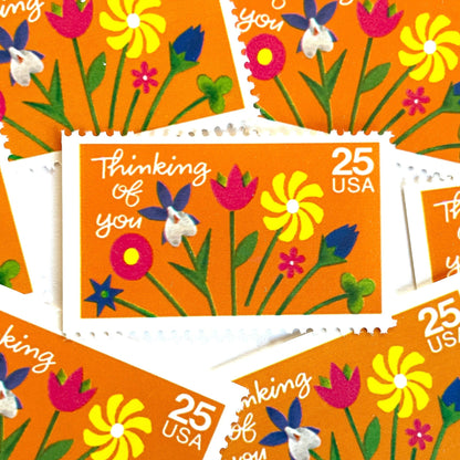 Thinking of You postage stamps from 1988 featuring colorful folk art flowers against a sunny orange background on vintage unused 25-cent USPS postage, Scott 2397.
