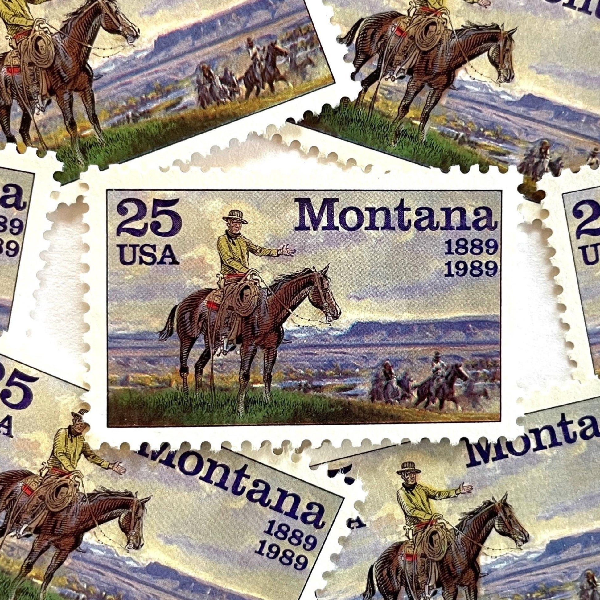 Image of Montana Statehood postage stamps from 1989, featuring C.M. Russell Western art with a cowboy on horseback and riders on vintage unused 25-cent USPS postage, Scott 2401.