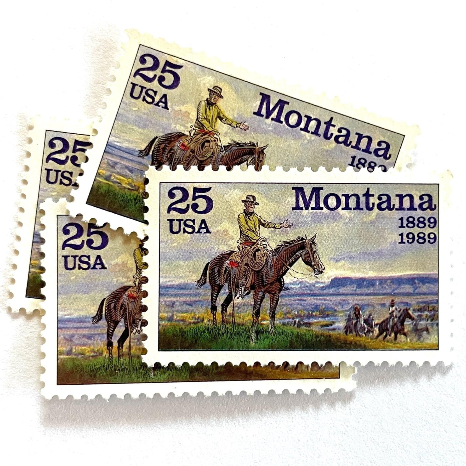 Image of Montana Statehood postage stamps from 1989, featuring C.M. Russell Western art with a cowboy on horseback and riders on vintage unused 25-cent USPS postage, Scott 2401.