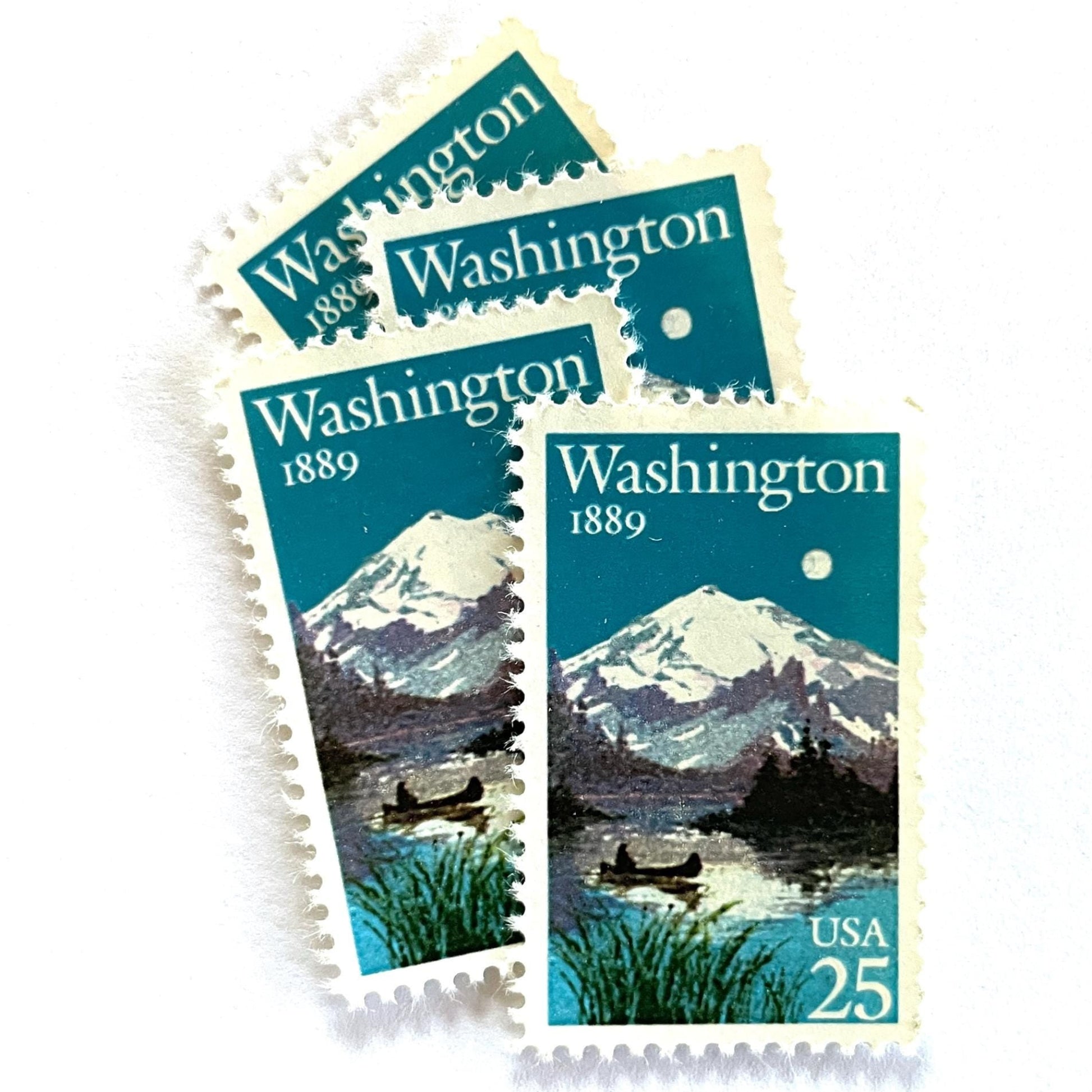 Image of Washington Statehood postage stamps from 1989, featuring Mount Rainier above a quiet lake with a canoe on vintage unused 25-cent USPS postage, Scott 2404.