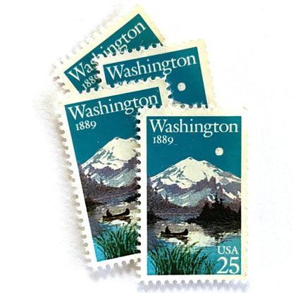 Image of Washington Statehood postage stamps from 1989, featuring Mount Rainier above a quiet lake with a canoe on vintage unused 25-cent USPS postage, Scott 2404.