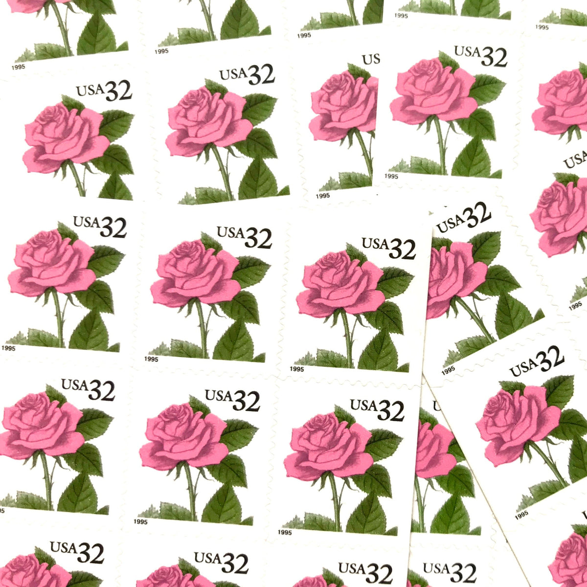 Vintage Pink Rose postage stamps from the 1995 Flora & Fauna series featuring a soft pink rose with green foliage on unused 32-cent USPS postage, Scott 2492.