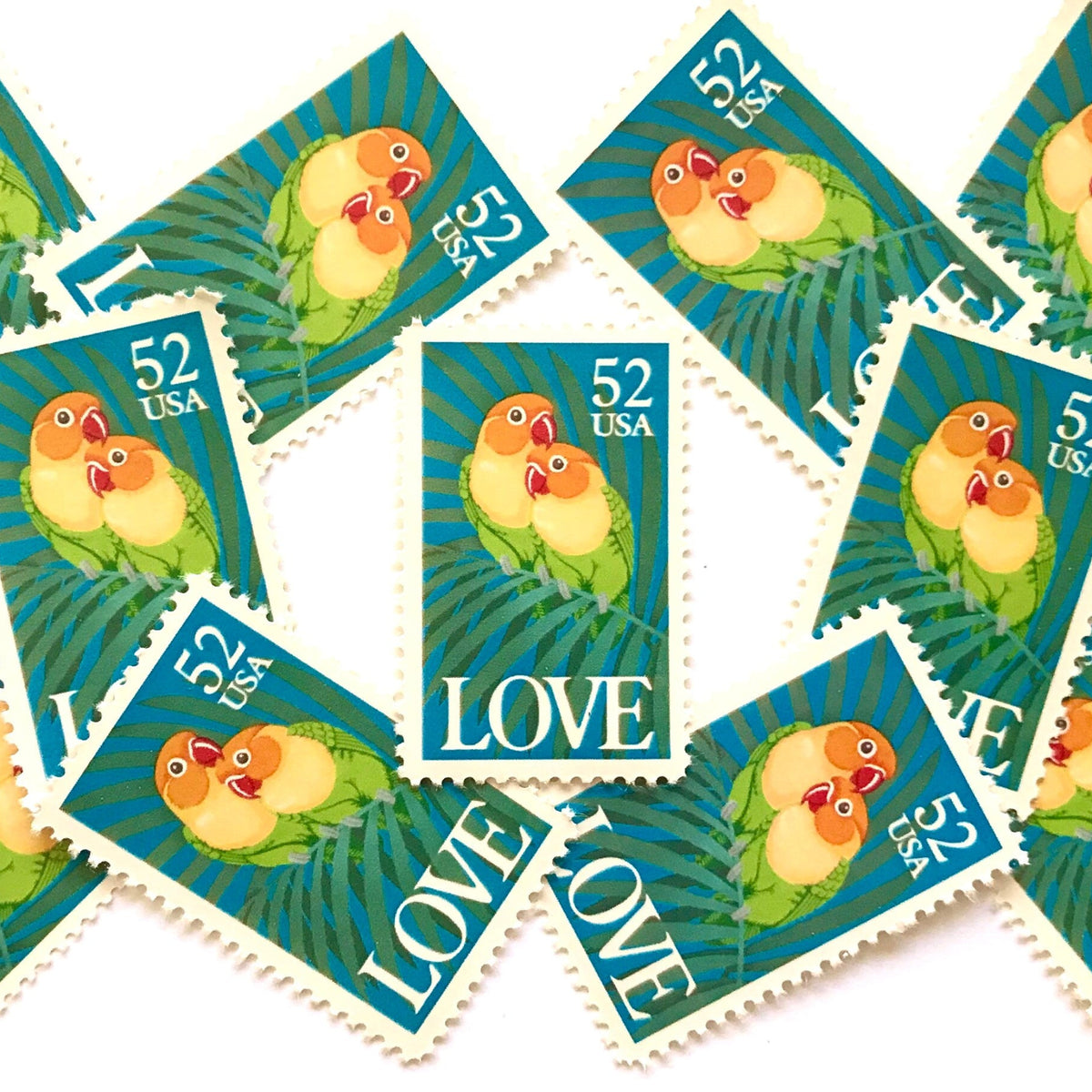 Love Birds postage stamps from 1991 featuring two colorful Fischer’s lovebirds cuddling on a palm frond on vintage unused 52-cent USPS postage, Scott 2537.