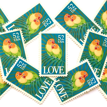 Love Birds postage stamps from 1991 featuring two colorful Fischer’s lovebirds cuddling on a palm frond on vintage unused 52-cent USPS postage, Scott 2537.