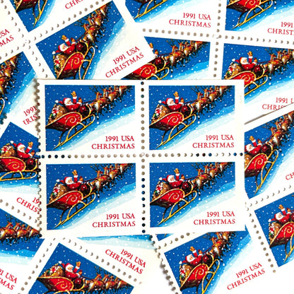 Image of 1991 Contemporary Christmas Series “Santa and Sleigh” 29-cent mail stamps. Scott #2585. Stamp Themes: Santa Claus, Santa’s Sleigh, Christmas, Holiday, Holidays, Winter, Night Sky, Snowing. Blue postage stamp.