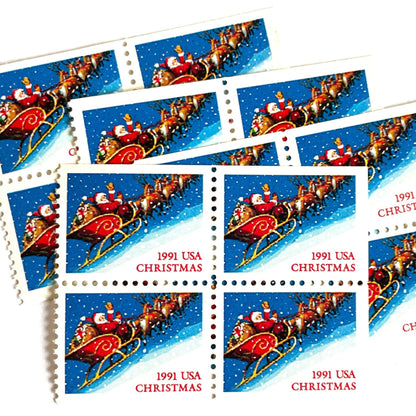 Image of 1991 Contemporary Christmas Series “Santa and Sleigh” 29-cent mail stamps. Scott #2585. Stamp Themes: Santa Claus, Santa’s Sleigh, Christmas, Holiday, Holidays, Winter, Night Sky, Snowing. Blue postage stamp.