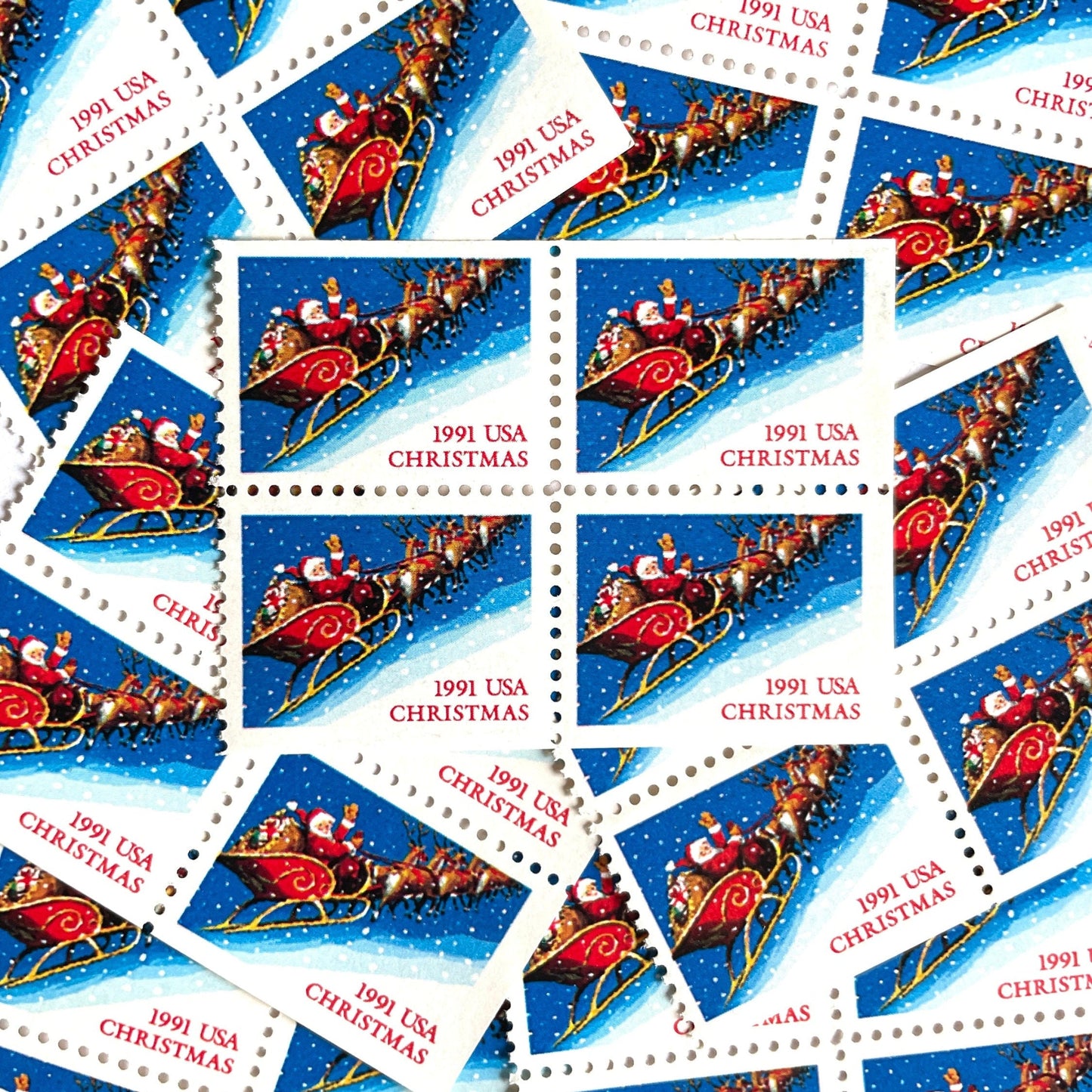 Image of 1991 Contemporary Christmas Series “Santa and Sleigh” 29-cent mail stamps. Scott #2585. Stamp Themes: Santa Claus, Santa’s Sleigh, Christmas, Holiday, Holidays, Winter, Night Sky, Snowing. Blue postage stamp.
