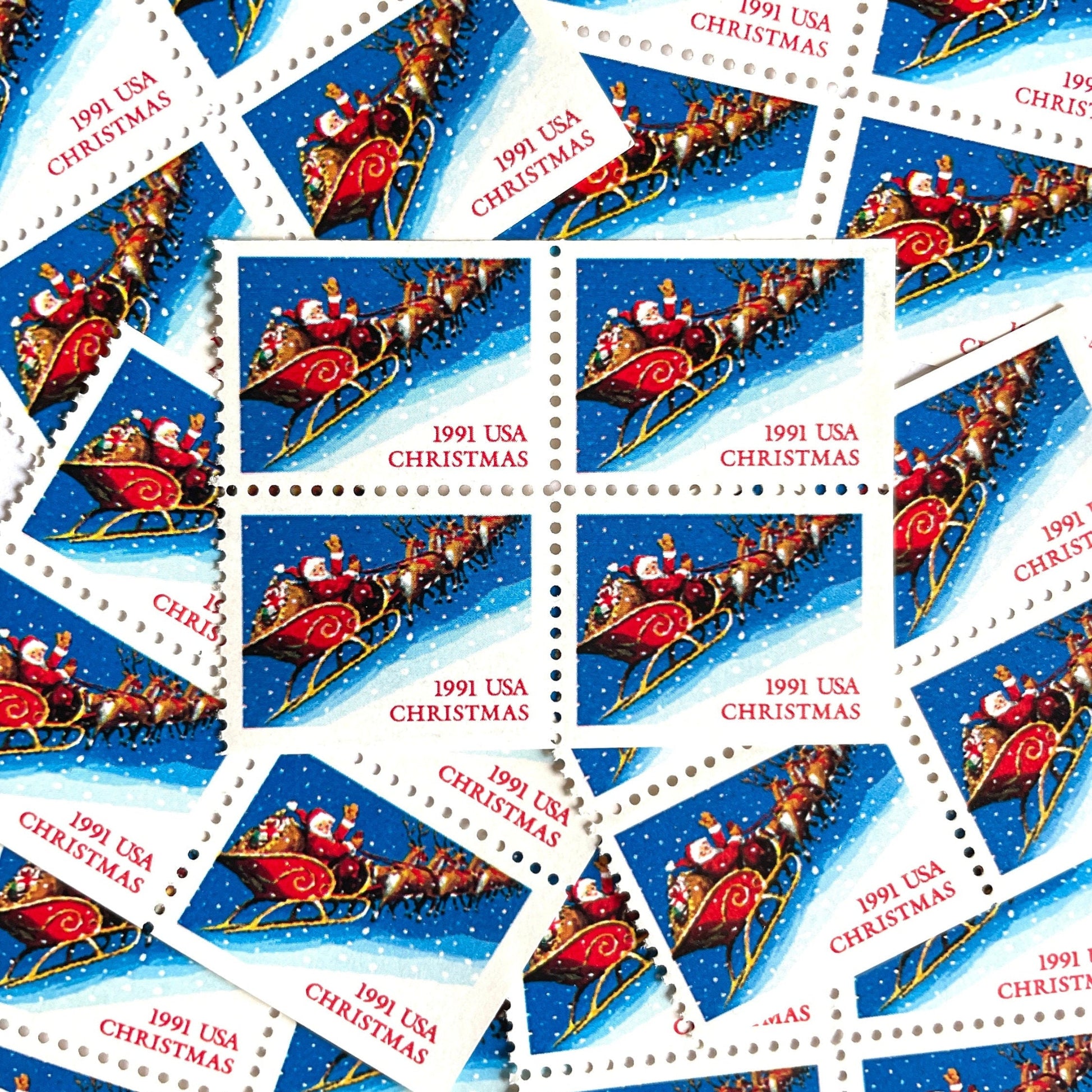 Image of 1991 Contemporary Christmas Series “Santa and Sleigh” 29-cent mail stamps. Scott #2585. Stamp Themes: Santa Claus, Santa’s Sleigh, Christmas, Holiday, Holidays, Winter, Night Sky, Snowing. Blue postage stamp.