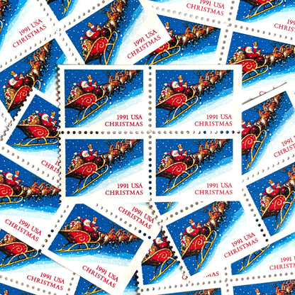 Image of 1991 Contemporary Christmas Series “Santa and Sleigh” 29-cent mail stamps. Scott #2585. Stamp Themes: Santa Claus, Santa’s Sleigh, Christmas, Holiday, Holidays, Winter, Night Sky, Snowing. Blue postage stamp.