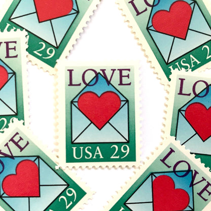Love Envelope and Heart postage stamps from 1992 featuring a red heart emerging from an open blue envelope on vintage unused 29-cent USPS postage, Scott 2618.