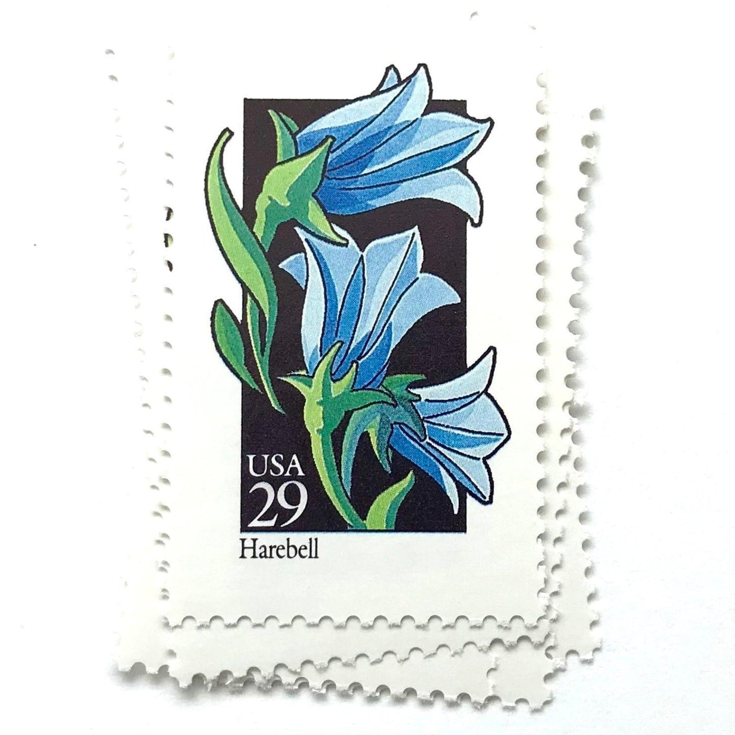 Image of 1992 American Wildflower Series “Harebell” vintage USPS mail stamps. Scott #2689. Stamp Themes: Plants, Flowers, Wildflowers, Flora. Blue, Green, Black, Multicolored gummed postage stamp. Perfect postage stamp to use for save the date announcements, wedding invitation postage, bridal shower invitations, birth announcements, valentine’s day, thank you cards, and snail mail.