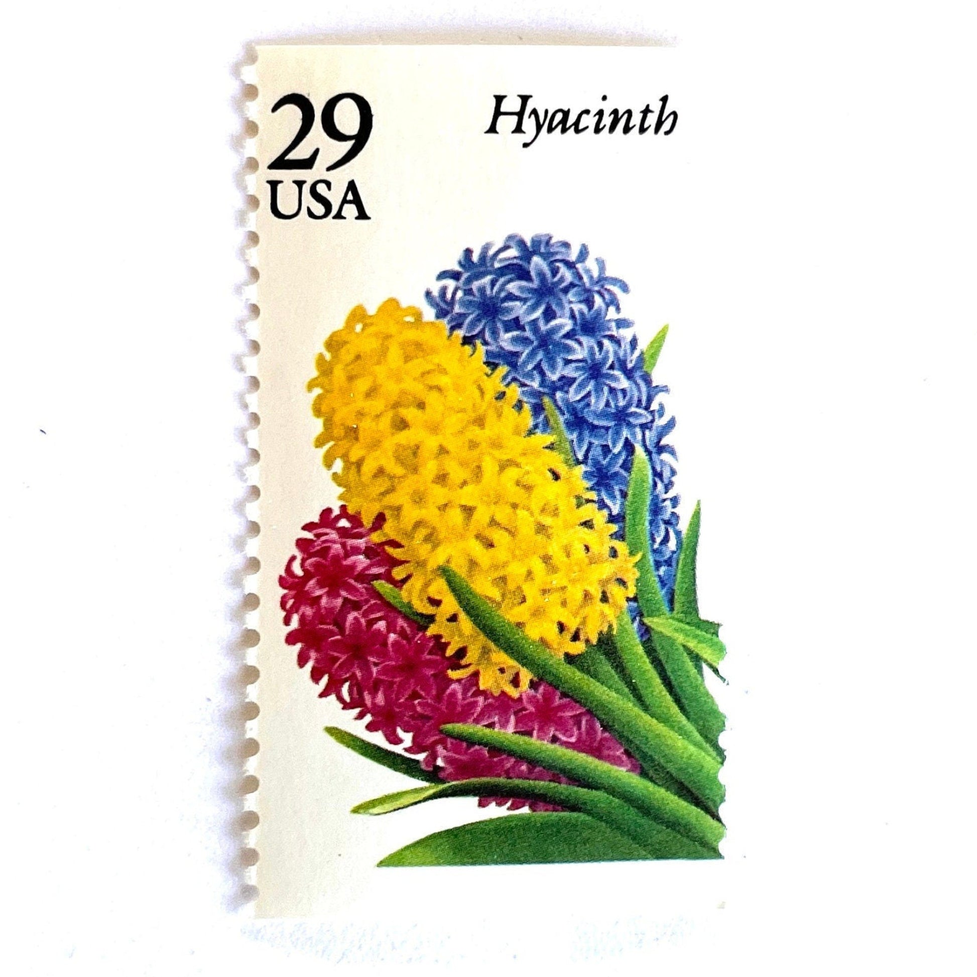 Image of Hyacinth postage stamps from the 1993 Spring Garden Flowers series, featuring purple hyacinth blooms with green foliage on vintage unused 29-cent USPS postage, Scott 2760. Colombian Flag Colors: Yellow, Blue, Red