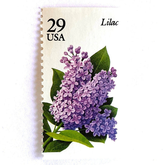Image of Lilac postage stamps from the Spring Garden Flowers series, featuring purple lilac blossoms with green leaves on vintage 1993 USPS 29-cent postage, Scott 2764.