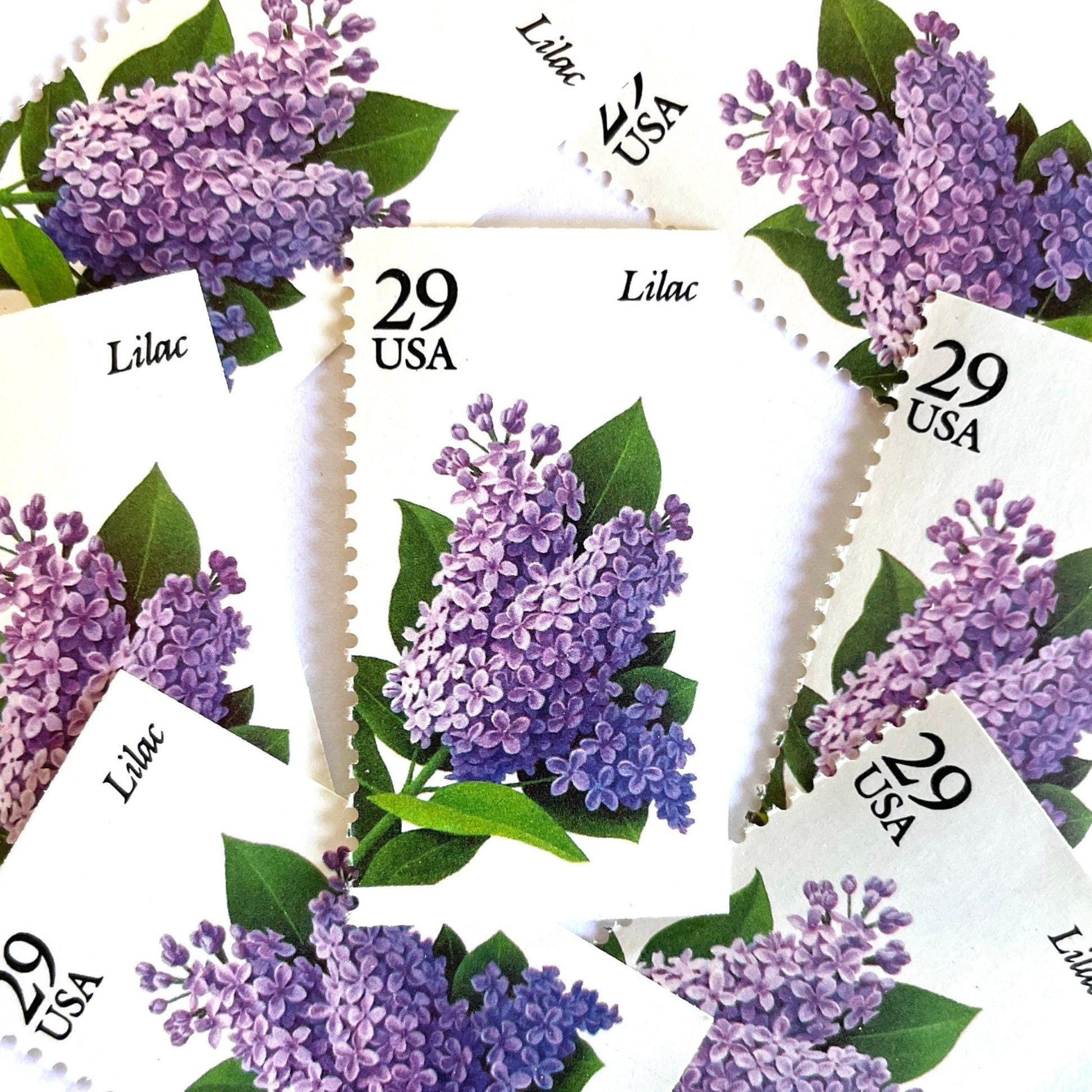 Image of Lilac postage stamps from the Spring Garden Flowers series, featuring purple lilac blossoms with green leaves on vintage 1993 USPS 29-cent postage, Scott 2764.