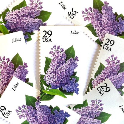 Image of Lilac postage stamps from the Spring Garden Flowers series, featuring purple lilac blossoms with green leaves on vintage 1993 USPS 29-cent postage, Scott 2764.