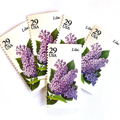 Image of Lilac postage stamps from the Spring Garden Flowers series, featuring purple lilac blossoms with green leaves on vintage 1993 USPS 29-cent postage, Scott 2764.