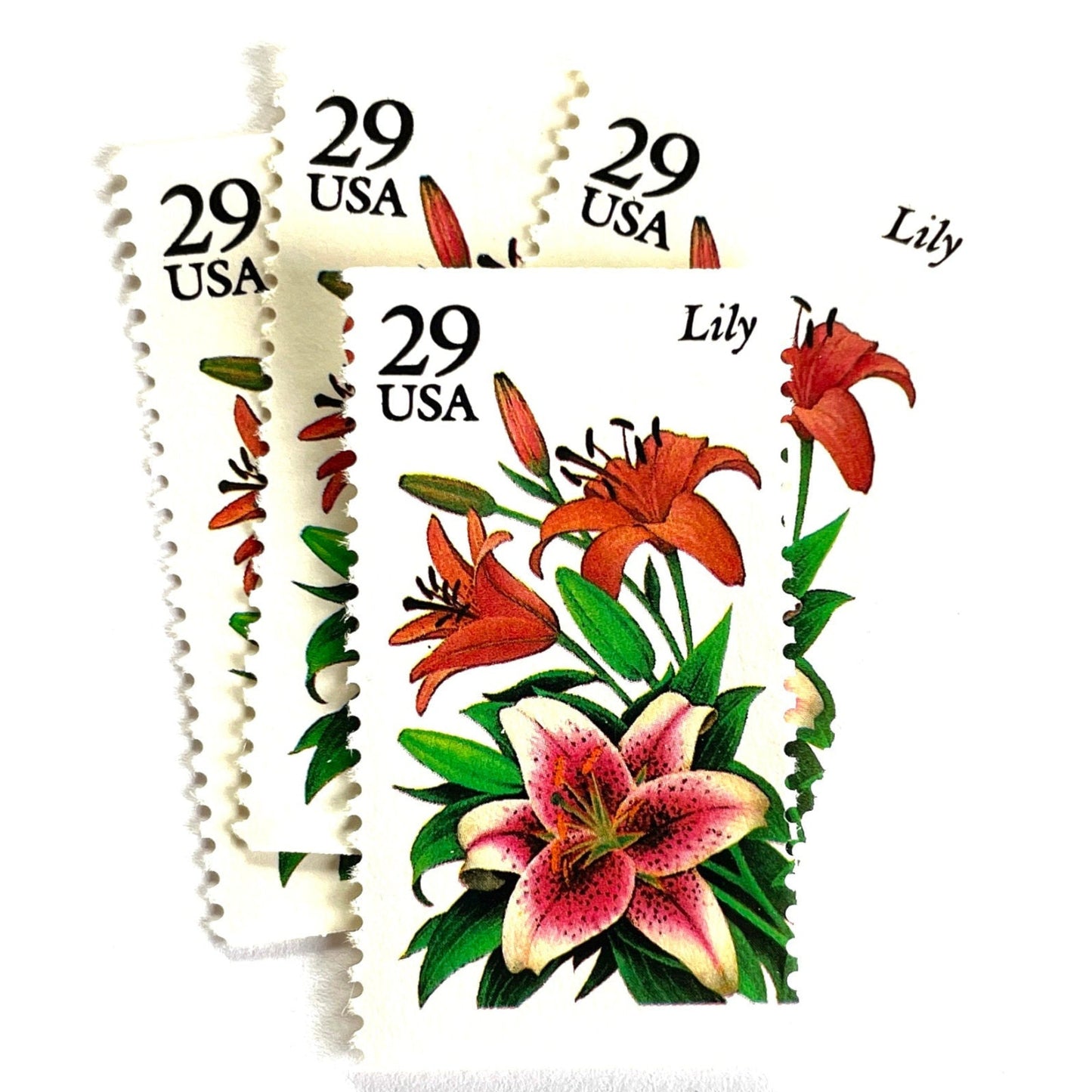 Image of Lily postage stamps from the 1994 Summer Garden Flowers series, featuring pink and red lily blossoms with green foliage on vintage unused 29-cent USPS postage, Scott 2829