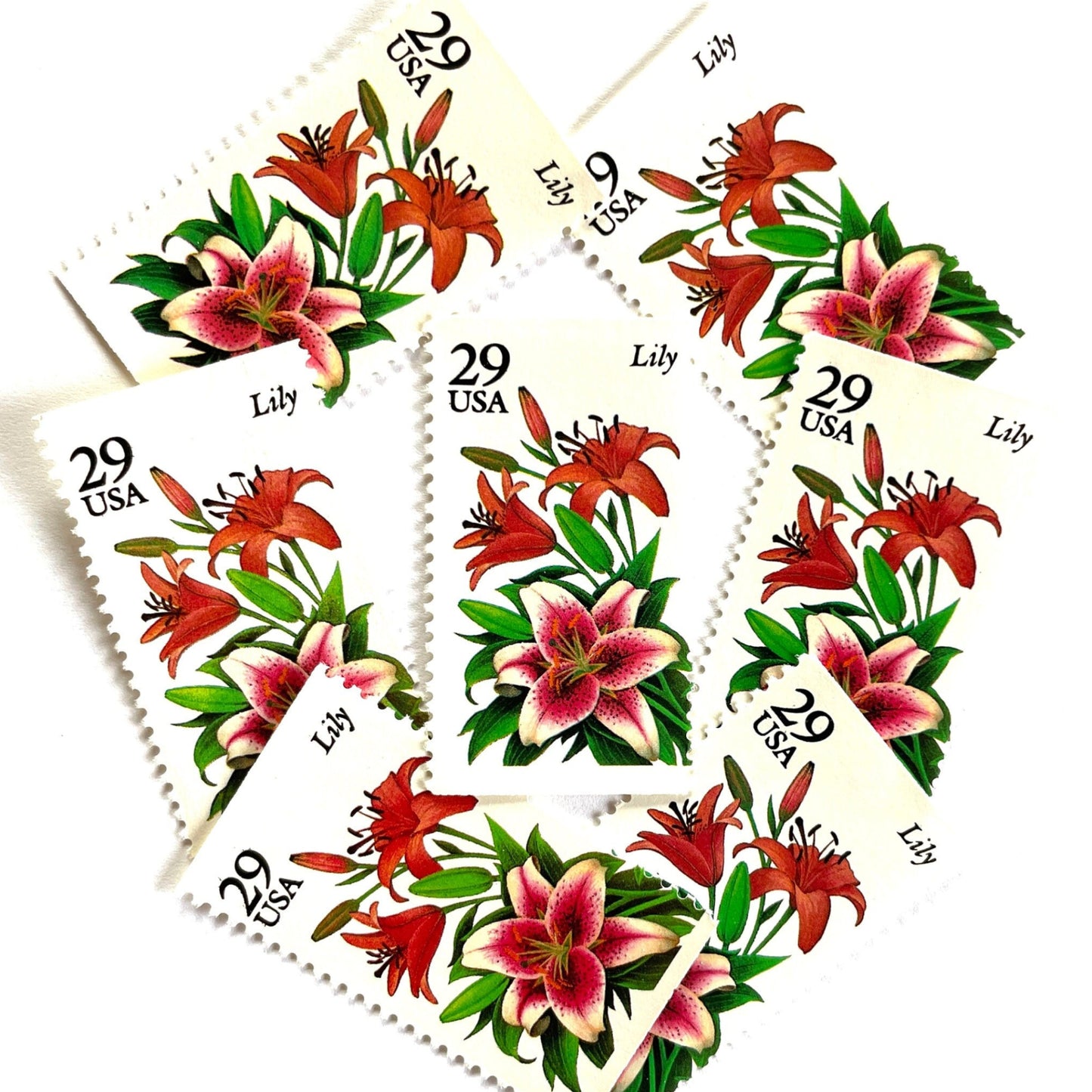 Image of Lily postage stamps from the 1994 Summer Garden Flowers series, featuring pink and red lily blossoms with green foliage on vintage unused 29-cent USPS postage, Scott 2829