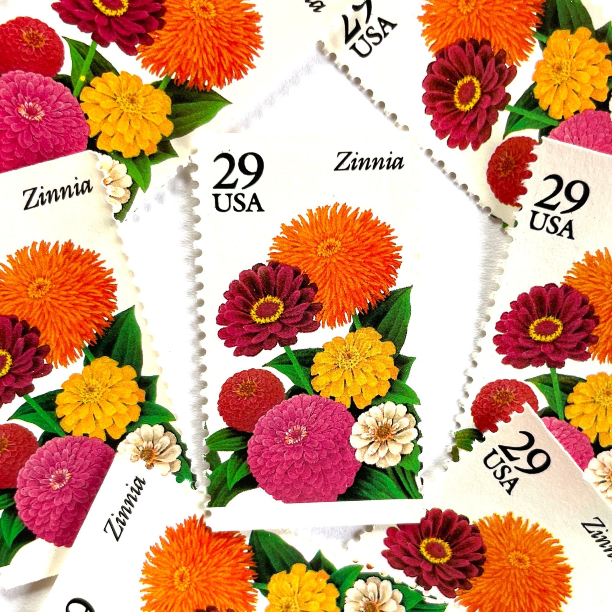 Image of Zinnia postage stamps from the 1994 Summer Garden Flowers series, featuring bright orange, pink, yellow, and cream zinnia blooms with green foliage on vintage unused 29-cent USPS postage, Scott 2830.