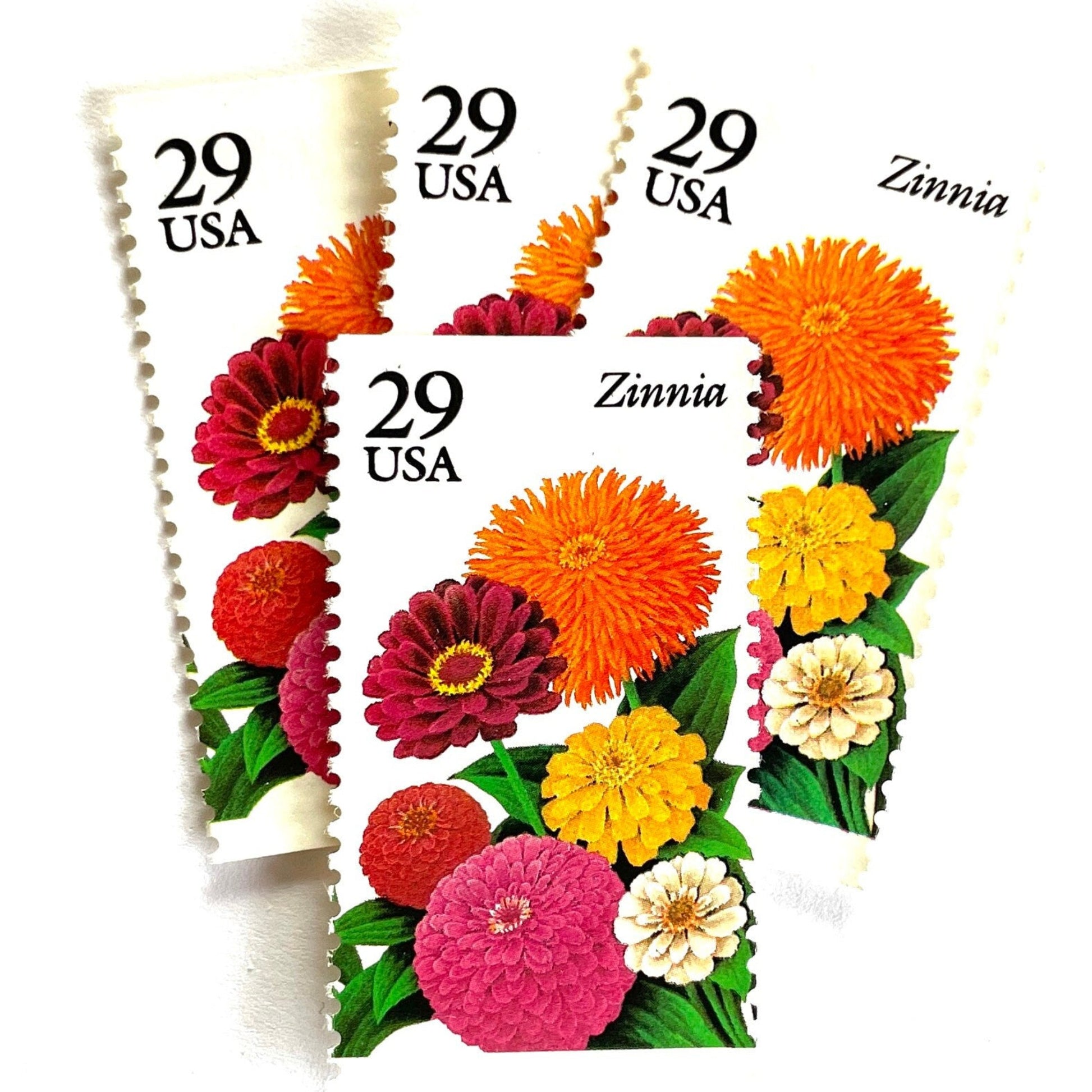 Image of Zinnia postage stamps from the 1994 Summer Garden Flowers series, featuring bright orange, pink, yellow, red, and cream zinnia blooms with green foliage on vintage unused 29-cent USPS postage, Scott 2830.