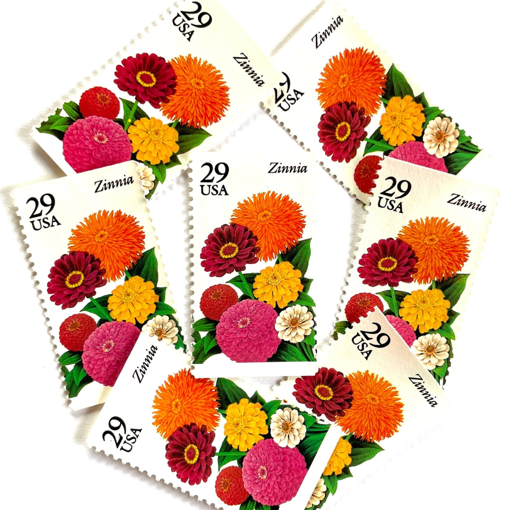 Image of Zinnia postage stamps from the 1994 Summer Garden Flowers series, featuring bright orange, pink, yellow, red, and cream zinnia blooms with green foliage on vintage unused 29-cent USPS postage, Scott 2830.