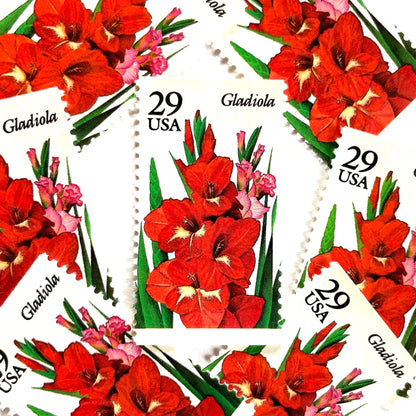 Image of Gladiola postage stamps from the 1994 Summer Garden Flowers series, featuring red-orange gladiola blossoms with green foliage on vintage unused 29-cent USPS postage, Scott 2831.