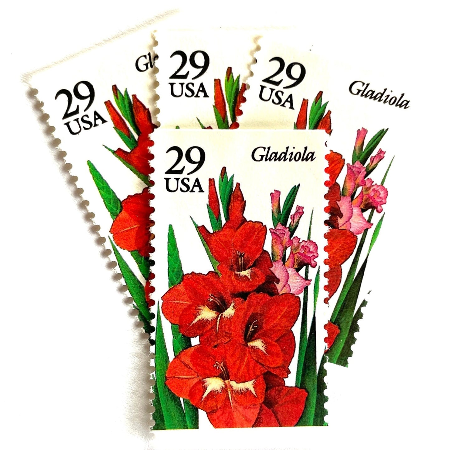 Image of Gladiola postage stamps from the 1994 Summer Garden Flowers series, featuring red-orange gladiola blossoms with green foliage on vintage unused 29-cent USPS postage, Scott 2831.