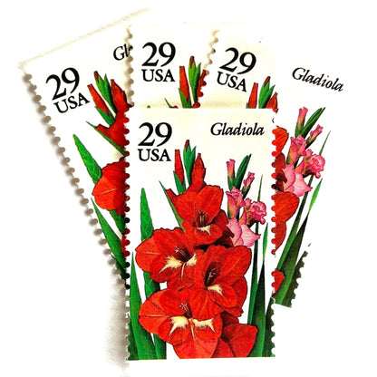 Image of Gladiola postage stamps from the 1994 Summer Garden Flowers series, featuring red-orange gladiola blossoms with green foliage on vintage unused 29-cent USPS postage, Scott 2831.