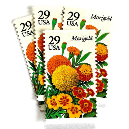 Image of Marigold postage stamps from the 1994 Summer Garden Flowers series, featuring orange, yellow, and red marigold blossoms with green foliage on vintage unused 29-cent USPS postage, Scott 2832