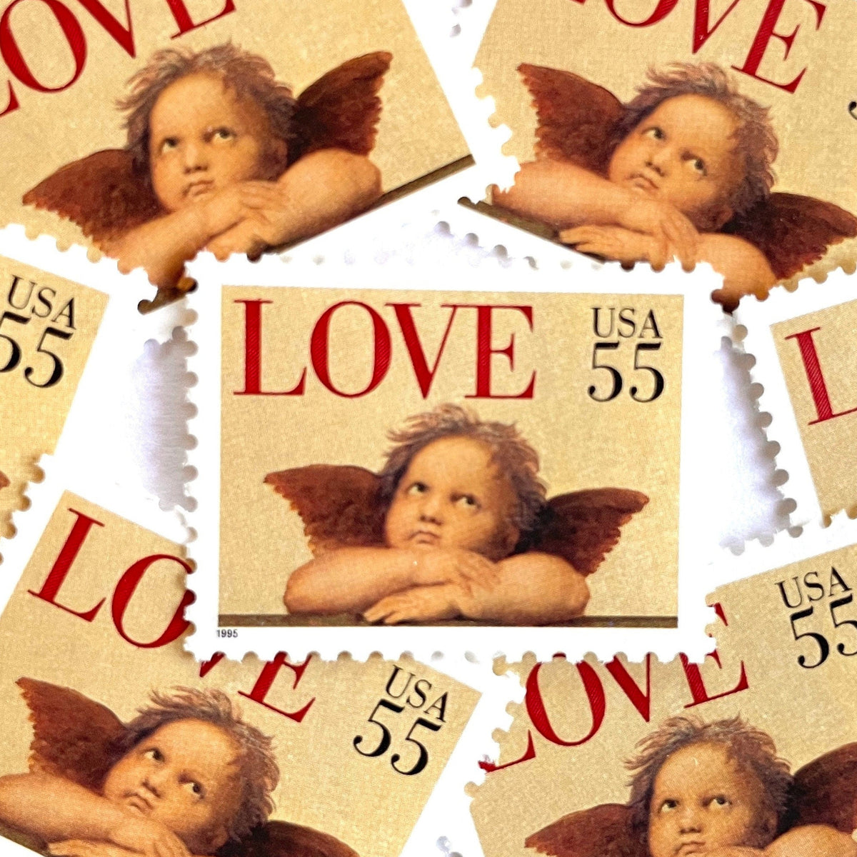 Cherub postage stamps from 1995 featuring a winged cherub in classical romantic style on vintage unused 55-cent USPS postage, Scott 2958.