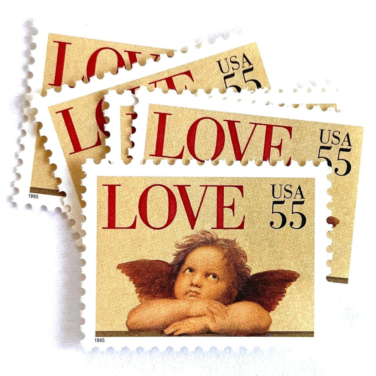 Cherub postage stamps from 1995 featuring a winged cherub in classical romantic style on vintage unused 55-cent USPS postage, Scott 2958.