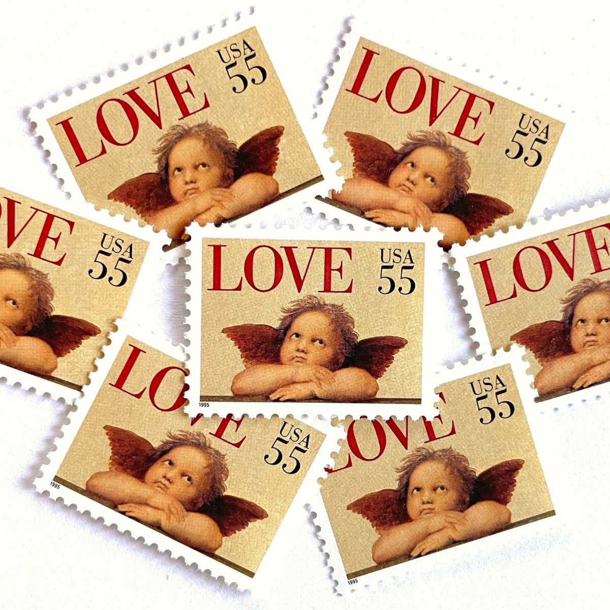 Cherub postage stamps from 1995 featuring a winged cherub in classical romantic style on vintage unused 55-cent USPS postage, Scott 2958.