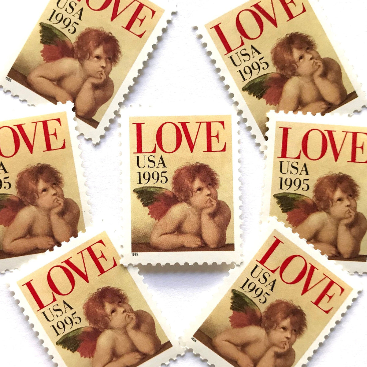 Cherub postage stamps from 1995 featuring Raphael’s contemplative cherub from the Sistine Madonna on vintage unused 32-cent USPS postage, Scott 2959.
